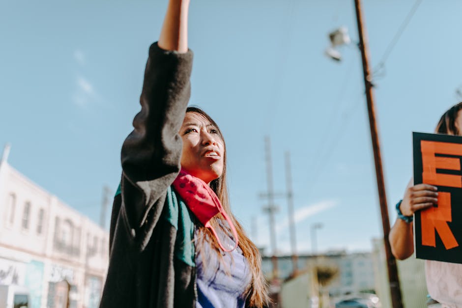 Young woman passionately demonstrating outdoors, expressing activism and solidarity.